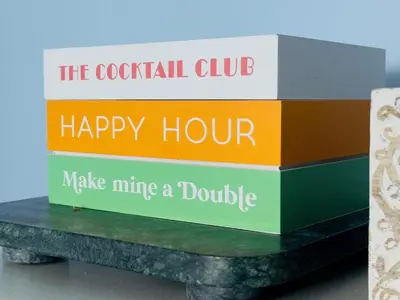 a stack of four books sitting on a table at The Cocktail Cabin! 2 Miles to Cedar Point in Sandusky