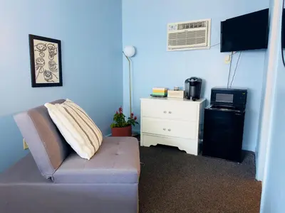 a living room with a couch and a white dresser at The Cocktail Cabin! 2 Miles to Cedar Point in Sandusky