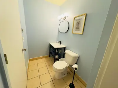 a bathroom with a toilet and a sink at The Cocktail Cabin! 2 Miles to Cedar Point in Sandusky