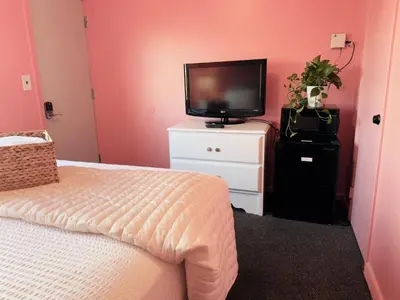 a bedroom with a bed and a television on a dresser at Cocktail Cabin Themed Guest Room in Sandusky