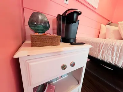 a bedroom with a table with a coffee maker on it at Cocktail Cabin Themed Guest Room in Sandusky