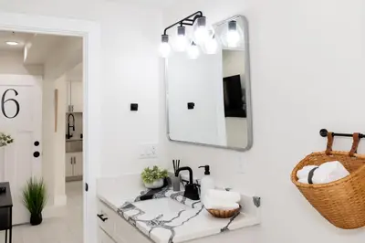 a bathroom with a sink and a mirror at Family Duplex Suite in Downtown Sandusky Sleeps 12! in Sandusky