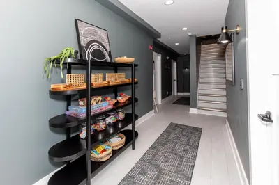 a hallway with a shelf of bread and baskets at Family Duplex Suite in Downtown Sandusky Sleeps 12! in Sandusky