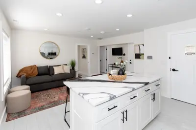 a kitchen and living room with a couch at Family Duplex Suite in Downtown Sandusky Sleeps 12! in Sandusky