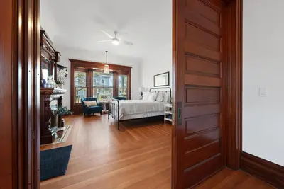 a bedroom with a bed and a living room at Boutique Style Condo Near Downtown Waterfront in Sandusky