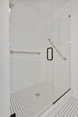 a shower with a glass door in a bathroom at Boutique Style Condo Near Downtown Waterfront in Sandusky