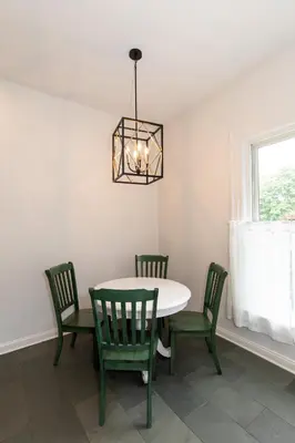 a dining room with a table and chairs and a chandelier at Boutique Style Condo Near Downtown Waterfront in Sandusky