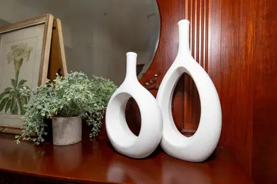 two white vases sitting on top of a table at Boutique Style Condo Near Downtown Waterfront in Sandusky