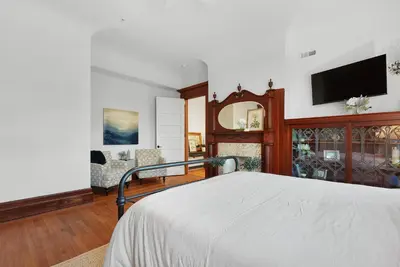 a bedroom with a bed and a flat screen tv at Boutique Style Condo Near Downtown Waterfront in Sandusky