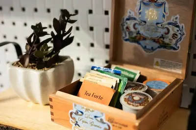 a box of tea liquids sitting on a table with a plant at Fauver Suite B in Dayton