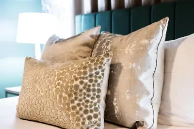 a group of pillows sitting on a bed at Fauver Suite B in Dayton