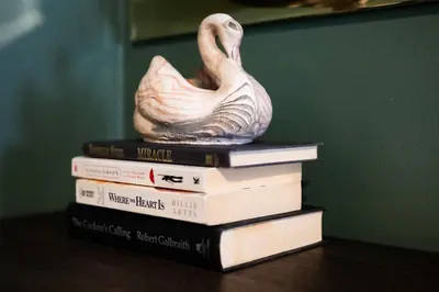 a stack of books with a statue of a duck on top at Fauver Suite B in Dayton