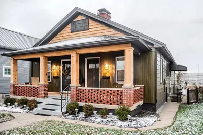 a small house with a front porch with a brick wall at Fauver Suite B in Dayton