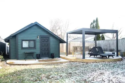 a green shed with a bench and a gazebo at Tiny Home for a King in Dayton