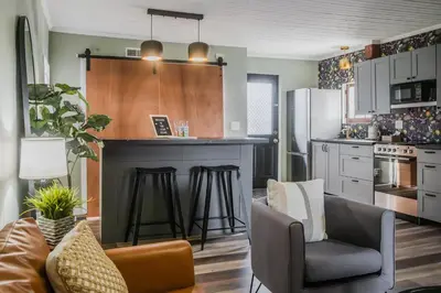 a kitchen with a counter and a bar with stools at Tiny Home for a King in Dayton