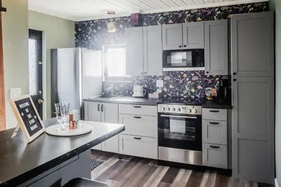 a kitchen with white cabinets and a stove at Tiny Home for a King in Dayton