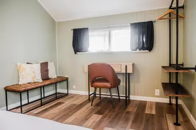 a room with a bed and a chair and a desk at Tiny Home for a King in Dayton