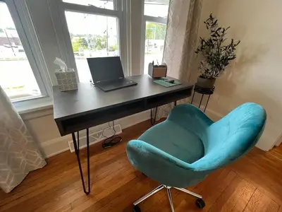 a desk with a laptop and a blue chair at Cozy at Anderson Towne Center in Cincinnati