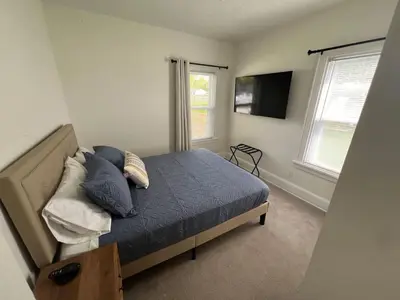 a bedroom with a bed with pillows and a television at Cozy at Anderson Towne Center in Cincinnati