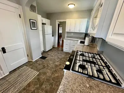 a kitchen with a stove top oven in a kitchen at Cozy at Anderson Towne Center in Cincinnati