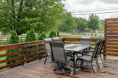 a table and chairs on a wooden deck at Amazing Pool & Walk to the Park in Cincinnati
