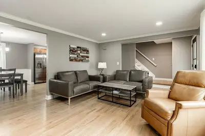 a living room with couches and a dining room at Amazing Pool & Walk to the Park in Cincinnati