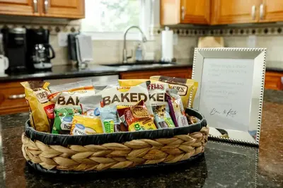 a basket filled with snacks on a counter in a kitchen at Amazing Pool & Walk to the Park in Cincinnati