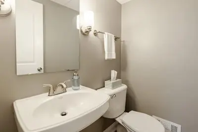 a bathroom with a sink and a toilet and a mirror at Amazing Pool & Walk to the Park in Cincinnati