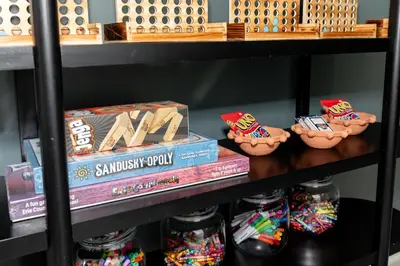 a shelf with some toy cookies and books at Adjoining Condominium Units Sleeps 12 in Downtown Sandusky! in Sandusky