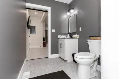 a bathroom with a white toilet and a sink at Adjoining Condominium Units Sleeps 12 in Downtown Sandusky! in Sandusky