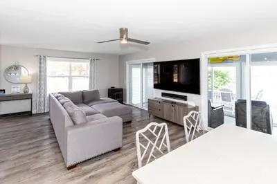 a living room with a couch and a table at At the Beach - Old Homestead Beach House in Huron