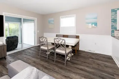 a dining room with a table and chairs at At the Beach - Old Homestead Beach House in Huron