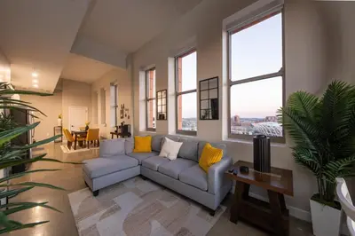 a living room with a couch and some windows at King Bed, Reds, Bengals, Free Parking, Downtown Cincy in Cincinnati