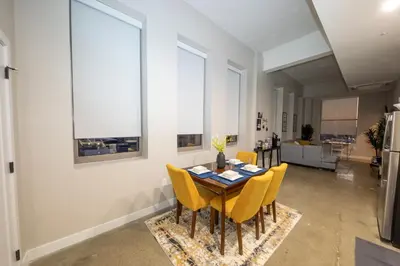 a dining room with a table and yellow chairs at King Bed, Reds, Bengals, Free Parking, Downtown Cincy in Cincinnati