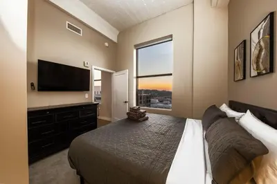 a bedroom with a bed and a flat screen tv at King Bed, Reds, Bengals, Free Parking, Downtown Cincy in Cincinnati