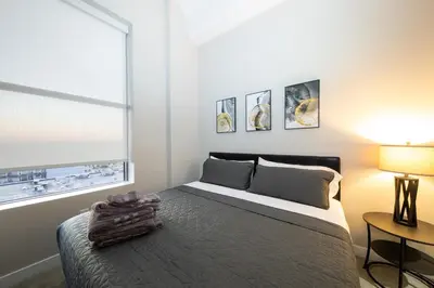 a bedroom with a large bed and a window at King Bed, Reds, Bengals, Free Parking, Downtown Cincy in Cincinnati
