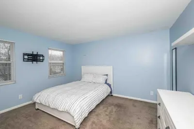 a bedroom with blue walls and a bed in it at Peaceful Dove in Tylersville