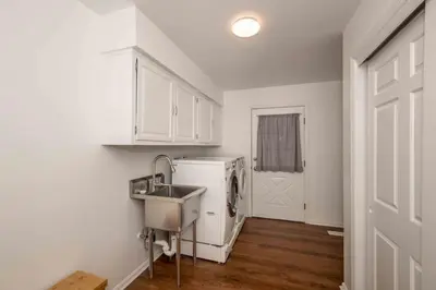 a kitchen with a sink and a washing machine at Peaceful Dove in Tylersville
