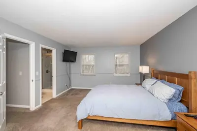 a bedroom with a bed and a flat screen tv at Peaceful Dove in Tylersville