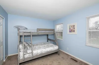 a bedroom with blue walls and a bunk bed at Peaceful Dove in Tylersville