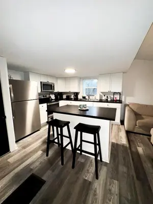 a kitchen with a counter and two stools in it at Buckeye Lake Getaway in Thornville
