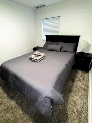 a bedroom with a large bed with a towel on it at Buckeye Lake Getaway in Thornville
