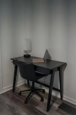 a black desk with a chair and a laptop on it at Buckeye Lake Getaway in Thornville