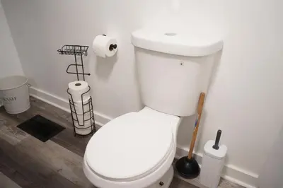 a bathroom with a white toilet in a room at Buckeye Lake Getaway in Thornville