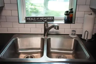a stainless steel sink in a kitchen with a window at Buckeye Lake Getaway in Thornville