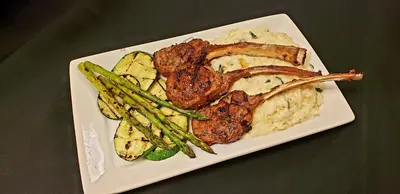 a plate of food with meat and mashed potatoes and asparagus at Hyatt Place at The Hollywood Casino Pittsburgh South in Washington