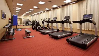 a gym with a row of treadms and cardio machines at Hyatt Place at The Hollywood Casino Pittsburgh South in Washington