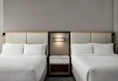 two beds in a hotel room with white pillows at SpringHill Suites by Marriot Troy Dayton in Troy