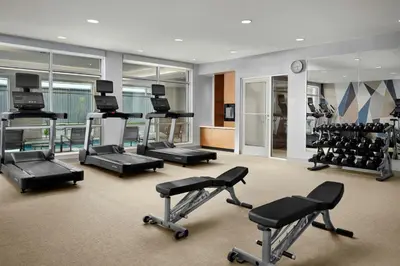 a gym with several treadmills and exercise bikes at SpringHill Suites by Marriot Troy Dayton in Troy