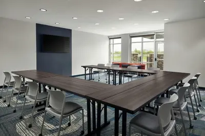 a conference room with a large wooden table and chairs at SpringHill Suites by Marriot Troy Dayton in Troy